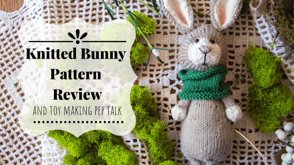 Knitted bunny with green cowl.