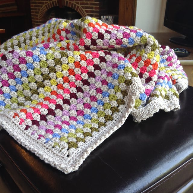bright striped crochet blanket with white border