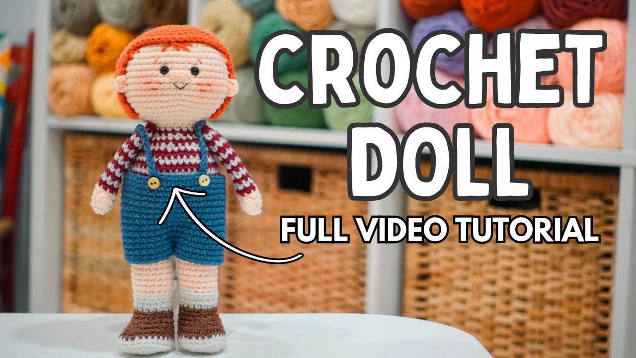 Sam Humphrey amigurumi boy doll wearing blue overalls and a red striped shirt